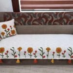 Refresh your home with the Handcrafted Floral Sofa Cover from TheLitLoom. Premium cotton blend, red & mustard embroidery, tassels, and matching cushions.