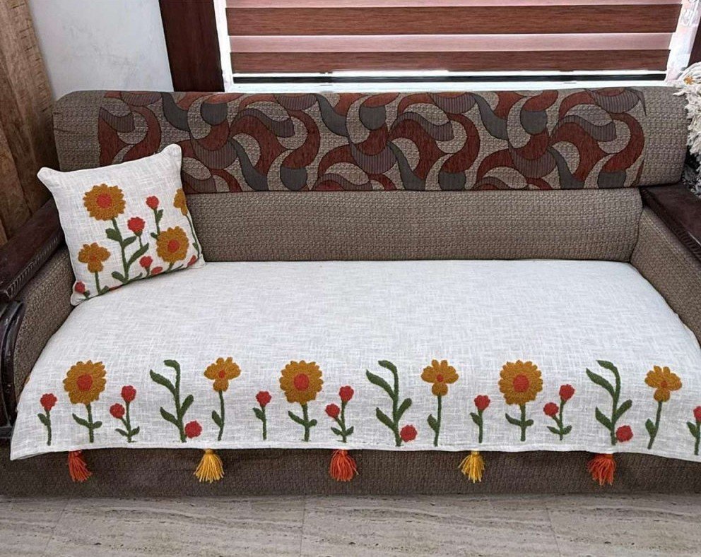 Refresh your home with the Handcrafted Floral Sofa Cover from TheLitLoom. Premium cotton blend, red & mustard embroidery, tassels, and matching cushions.